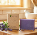 Lavender & Goats Milk - Bar Soap next to fresh lavender flowers on a wooden surface in natural light