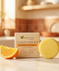 Conditioner Bar - Citrus with natural lemongrass and sweet orange scent beside an orange slice on kitchen counter
