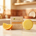 Conditioner Bar - Citrus with natural lemongrass and sweet orange scent beside an orange slice on kitchen counter