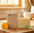 Aloe Vera & Calendula - Bar Soap with natural ingredients displayed with calendula flower and aloe vera slice on wood surface