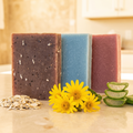 Oatmeal, Milk & Honey - Bar Soap | Arnica & Mint - Bar Soap | Oatmeal & Aloe - Bar Soap with natural ingredients on countertop