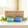 Shampoo & Conditioner Set - Rosemary and Mint with natural blue and green bars alongside fresh rosemary and mint leaves