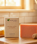 Manuka Honey and Turmeric - Bar Soap displayed with honeycomb and wooden honey dipper on wood countertop